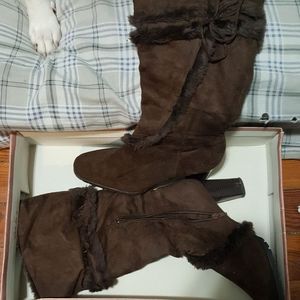 Brown knee high boots with a heel
